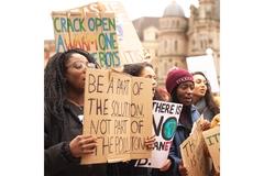 Climate activists holding protest signs calling for environmental action